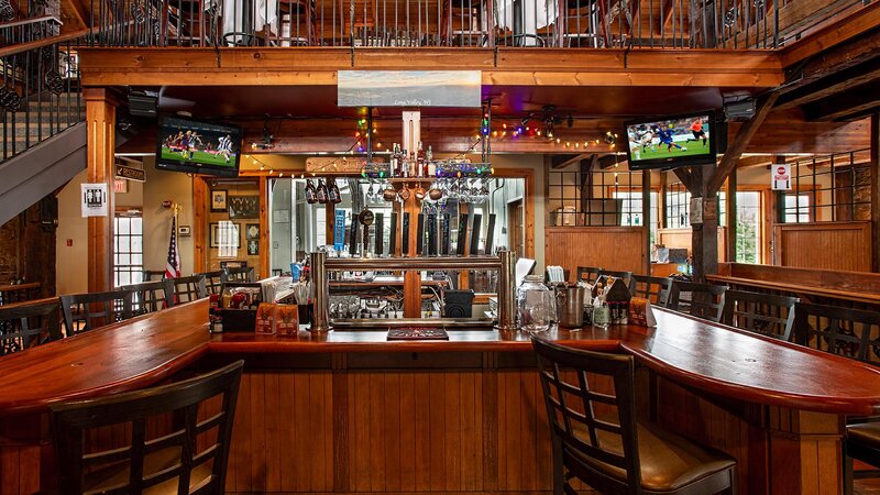 Bar with view of beer taps and televisions
