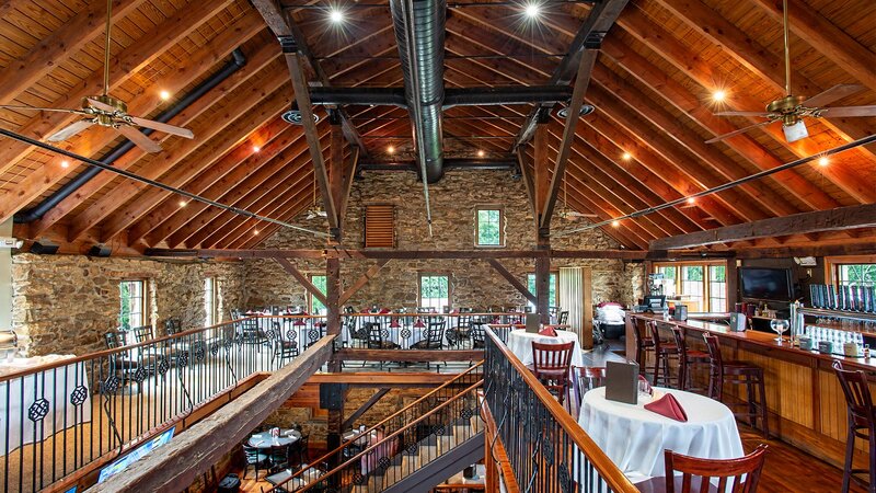 Second floor private party room with view of set tables and staircase