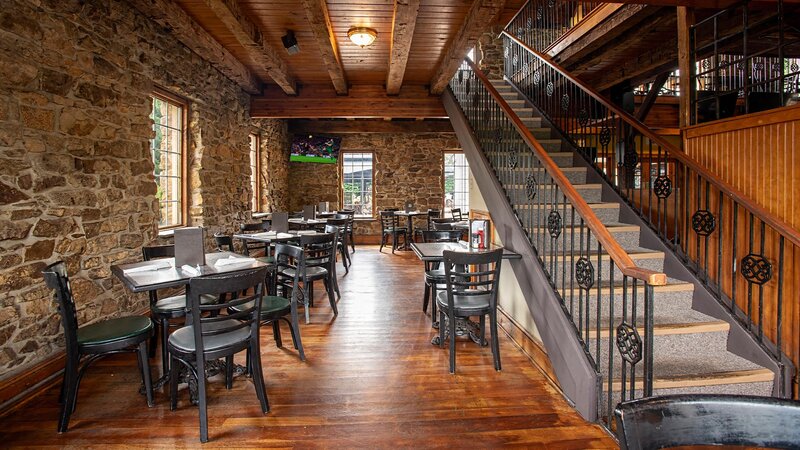 Dining room with stairs leading to upstairs dining room